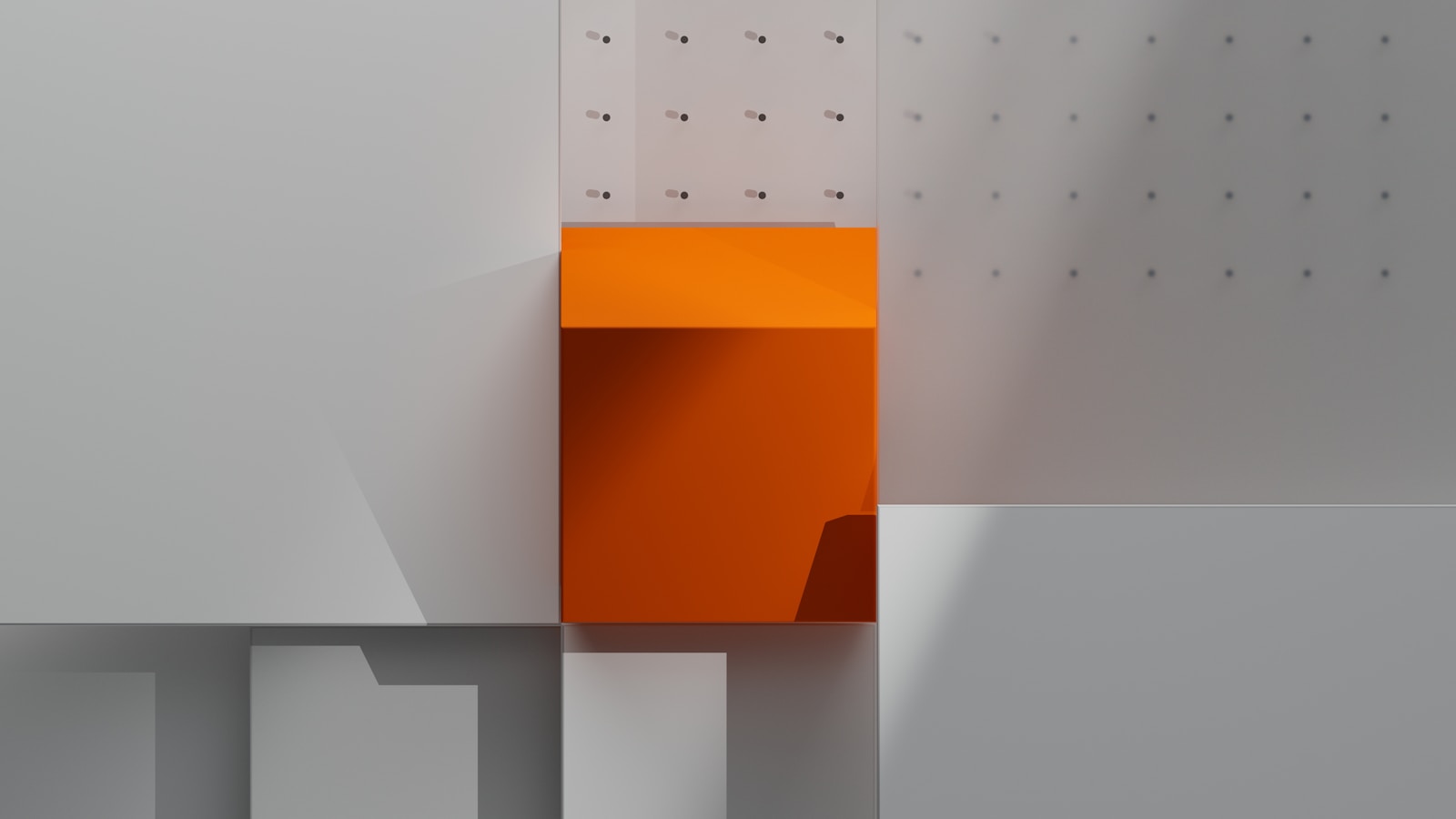 A close up of a white wall with a orange block